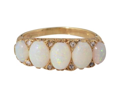 A five stone opal ring oval cabochon opals of graduating form with diamond points set between, set within pierced scrolling g