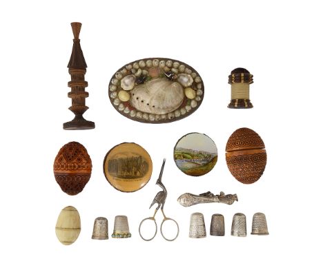 A collection of 19th century and later sewing itemscomprising egg shaped carved coquilla nut pommander and etui case, a rever