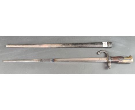 A French M1874 gras bayonet and scabbard, inscribed&nbsp;'St Etienne 1880'.