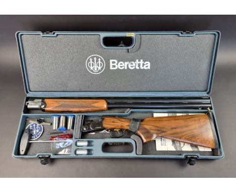 A Beretta 682 gold over and under 12 bore shotgun, in original case, with five chokes, tools, snap caps and some spares, Seri