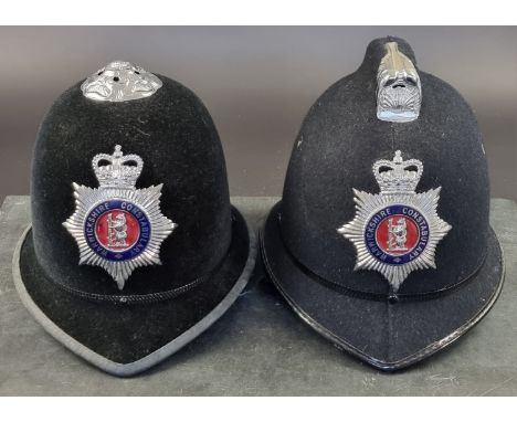Two Warwickshire Police Custodian helmets, one with rose top; the other with comb top. (2)