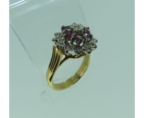 A ruby and diamond cluster Dress Ring, all mounted in unmarked yellow and white gold, tested as 9ct, Size M½, approx. total w