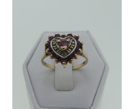 A ruby and diamond heart shaped Ring, all mounted in 9ct yellow gold, Size N, 2.1g. 