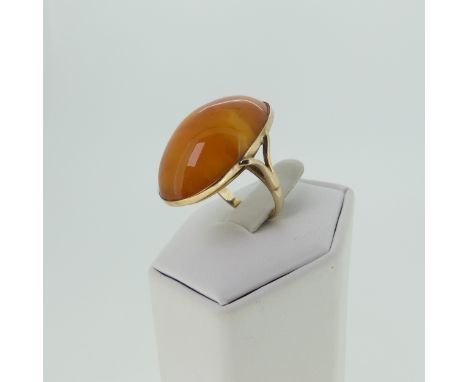 An antique amber cabochon Ring, 27mm long, mounted in unmarked yellow gold, tested as 9ct gold, Size L, 6.1g, with accompanyi