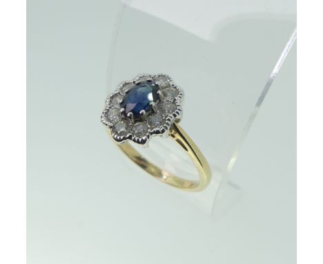 A sapphire and diamond cluster Ring, the central oval facetted sapphire approx. 5.6x4.1mm, surrounded by ten circular diamond