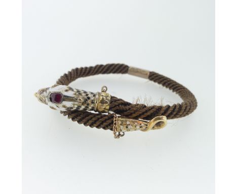 A 19thC snake memorial Bangle, formed of woven hair with enamelled snake head and tail finials, the head set with a garnet, u