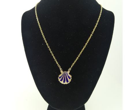 An antique scallop shell memorial Pendant, the front with five rays of blue enamel, the reverse with central oval box and gla