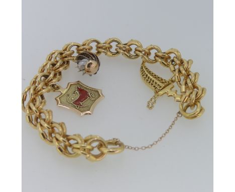 An 18ct gold fancy link Bracelet, with three gold charms suspended, including a 14ct Taurus plaque, a baroque cultured pearl 