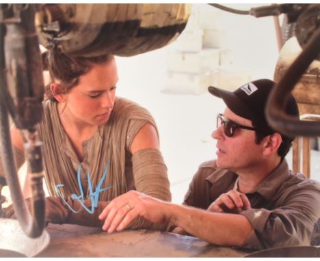 Star Wars - JJ Abrams (Director) - autographed 11x14" photograph showing Abrams alongside Daisy Ridley, on set. Signed in blu