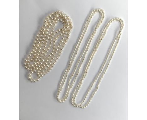 A long freshwater pearl single strand necklace, 67cmL; together with two rice pearl necklaces, each 45cmL 