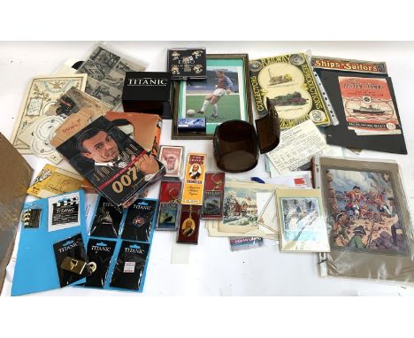 A mixed lot to include UEFA Euro 96 badges, Titanic collectors items, cigarette card reference books, James Bond trading card