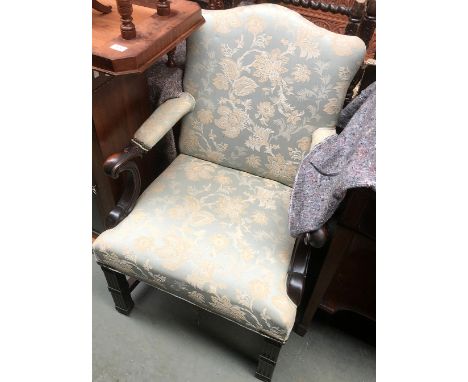 A George III style upholstered open armchair, carved arm terminals, on carved chippendale style square section front legs, 64