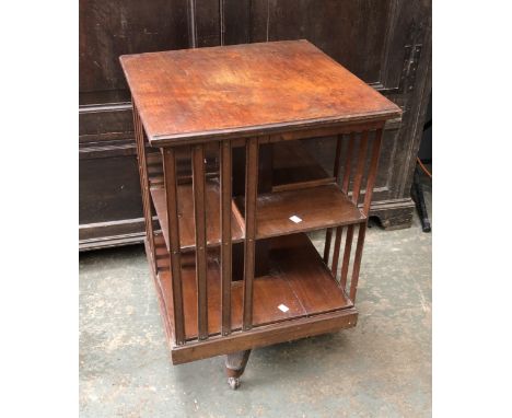 An Edwardian rotating mahogany bookshelf, on ceramic casters, 49x49x77cmH 