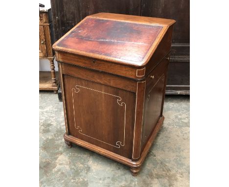 A mahogany and bone inlaid davenport desk, the sliding top with leather inset slope, the interior with six drawers, flanked e