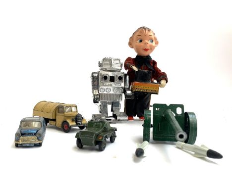 A West German tin plate magician with pan revealing chick below, together with a Japanese robot, Dinky Bedford truck, Dinky s