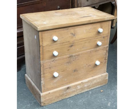 A 19th century pine commode chest, the hinged top and front opening to a seat with lift off lid and ceramic liner, on plinth 