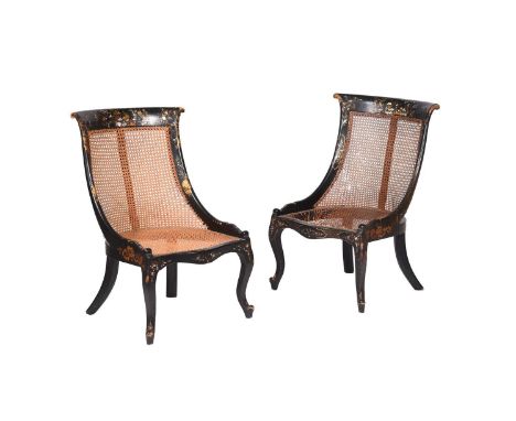A pair of Victorian black lacquered papier mache chairs, c.1860 in the manner of Jennens &amp; Bettridge, the caned swept bac