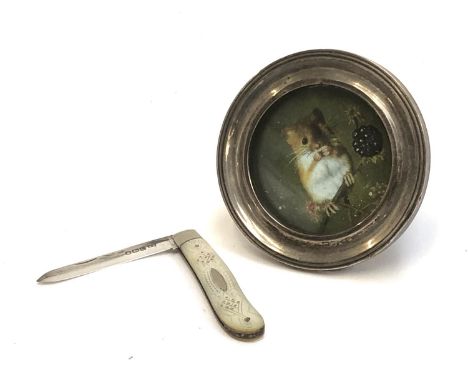 A small silver and mother of pearl penknife by William Needham, Sheffield 1920; and a small silver circular picture frame, in