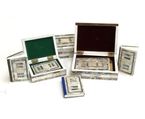 Five Qurans in abalone and mother of pearl covers, three within matching caskets, the largest casket 17.5cmW 