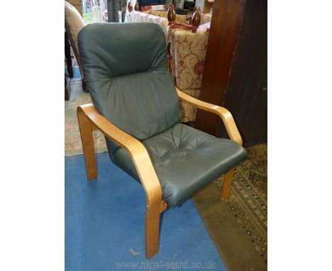 A contemporary light hardwood bentwood framed easy chair having green leather upholstered seat/backrest.