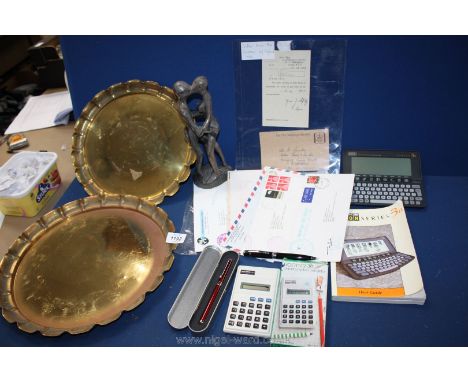 A quantity of miscellaneous including two brass charges, Psion 3A, a letter from the Home Office, Boots calculator, first day