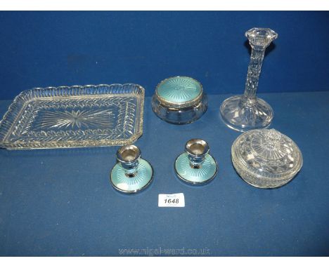 A part dressing table set with blue enamel candlesticks and an enamelled powder bowl, a clear glass candlestick and a clear l