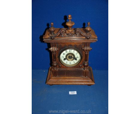 A German wooden eight day strike mantle clock with columns each side and a small crack down the centre.