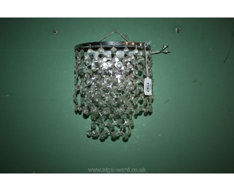 A contemporary wall light/chandelier having chromium plated finish fittings and small bulb illumination, approx. 8" wide x 9 
