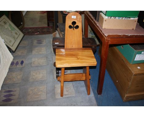 A light hardwood Arts and Crafts Chair having pierced shamrock motif to the backrest, the slab legs united by a pegged stretc