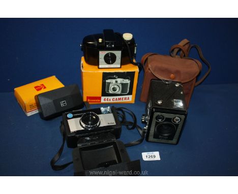 A boxed Brownie Six-20 camera model E with flash contents in a case, a cased Kodak 155x Instamatic camera, a boxed Brownie 44