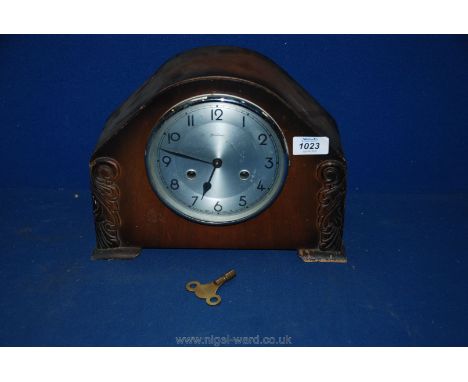 A Bentima mantle Clock with Arabic numerals and key.