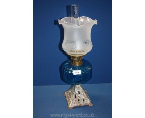 A blue glass oil Lamp with metal base with heron detail. 22" tall.