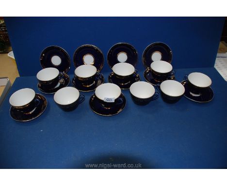 A quantity of Russian made cups and saucers:  ten cups, eleven saucers with gold garland and floral design to outer rims on r