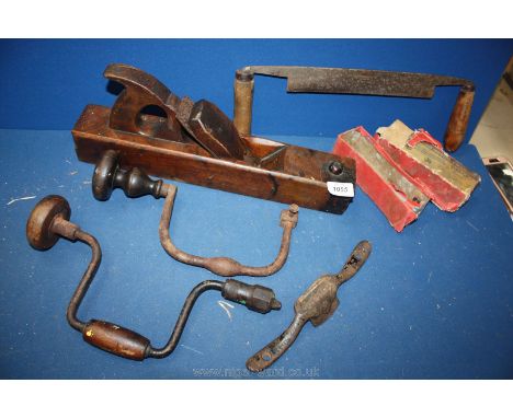 A box of early 20th Century woodworking tools; brace and bit, plane, draw knife, etc.