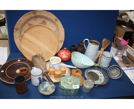 A box of mixed wooden and enamel items, jugs, jelly moulds, wooden tray, green sieve.