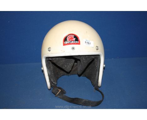 An old motorcycle Helmet having Centurion badge to the front.