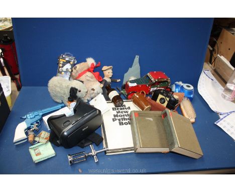 A quantity of miscellanea including Meccano car, Polaroid camera, Viewer, Monty Python book, straw stuffed dog, toy sailor do