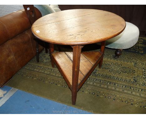 An Early 19th C. Cricket table with stretcher shelf being 30" diameter and 29" high.