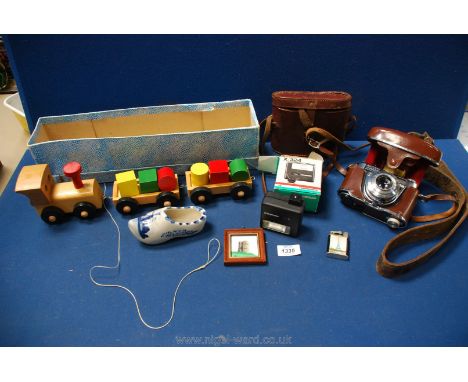 A quantity of miscellanea including:  wooden toy train, Delft clog, souvenir of Paris lighter, Kodak Retinette 18 camera etc.