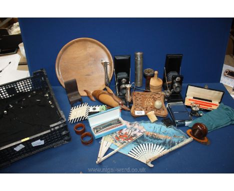 A quantity of miscellanea to include; camera bookends, harmonica, wooden items including; Dolphin, fans, etc.