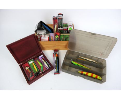An Abu Garcia tackle box and two wooden boxes with Rapala lures, various styles and sizes.