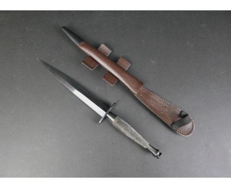 J Nowill a second pattern Commando knife, stamped with a broad arrow and with sheath with 7" blade, 20 cm overall.  This blad