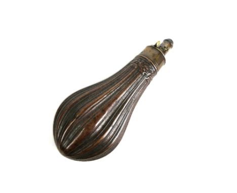 A brass and copper powder flask, with ribbed body.  Length +/- 21 cm.