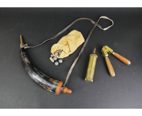 A bullet mould together with horn powder flask, a modern powder flask and bag of lead balls.