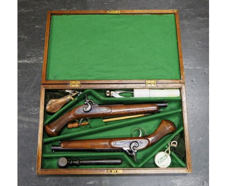 A pair of AMR cal 44 black powder percussion pistols, with 10" barrels, the locks and hammers with sparse decoration and with