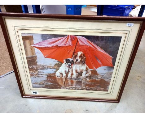 A framed print of dogs under an umbrella 