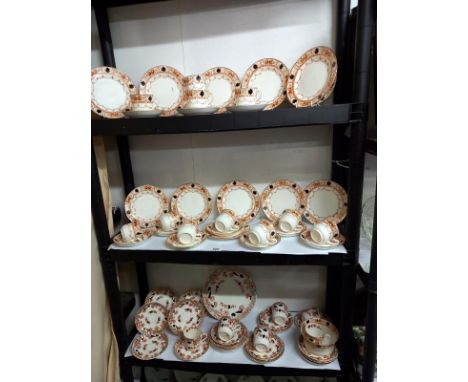 Two vintage tea sets over three shelves. 