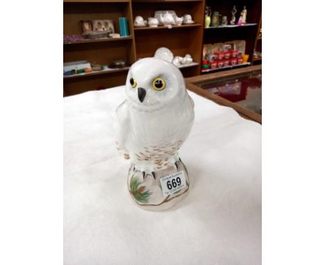 A Crown Staffordshire fine bone china snowy owl on a pine tree log.  Signed M.R.T with a K scratched into the base before fir
