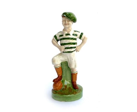 A glazed ceramic figure of a footballer, 36cmH