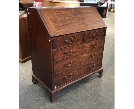 A George III mahogany bureau, the fall front opening to a fitted interior, over two-short and three graduating drawers on bra